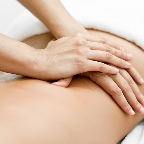 A Woman receiving a back massage | Spa Vela in Flower Mound, Texas